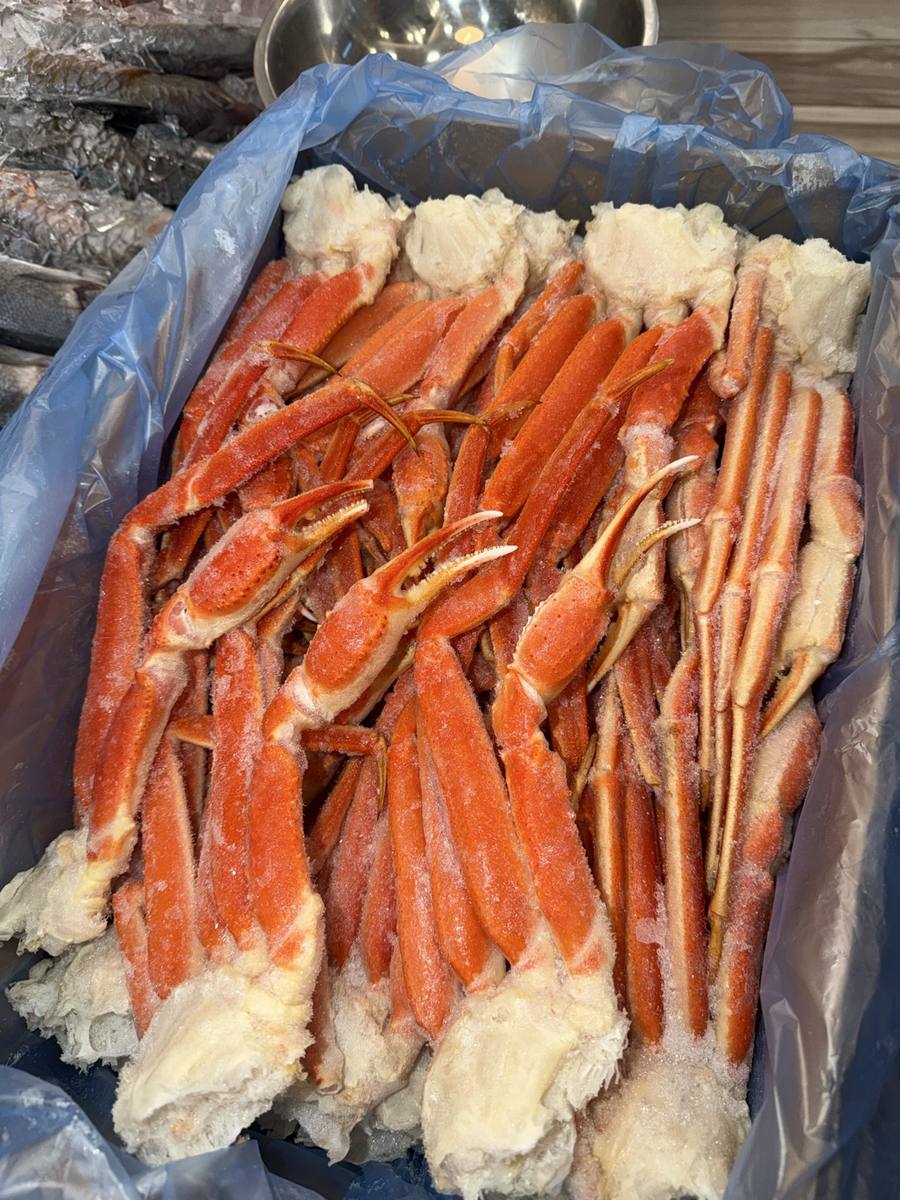 Crab legs, salmon, potatoes and vegetables